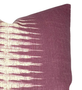 Square pillow cover featuring a gradient ikat pattern with cream spikes fading into a rich mauve background, shown from a close-up angled view.