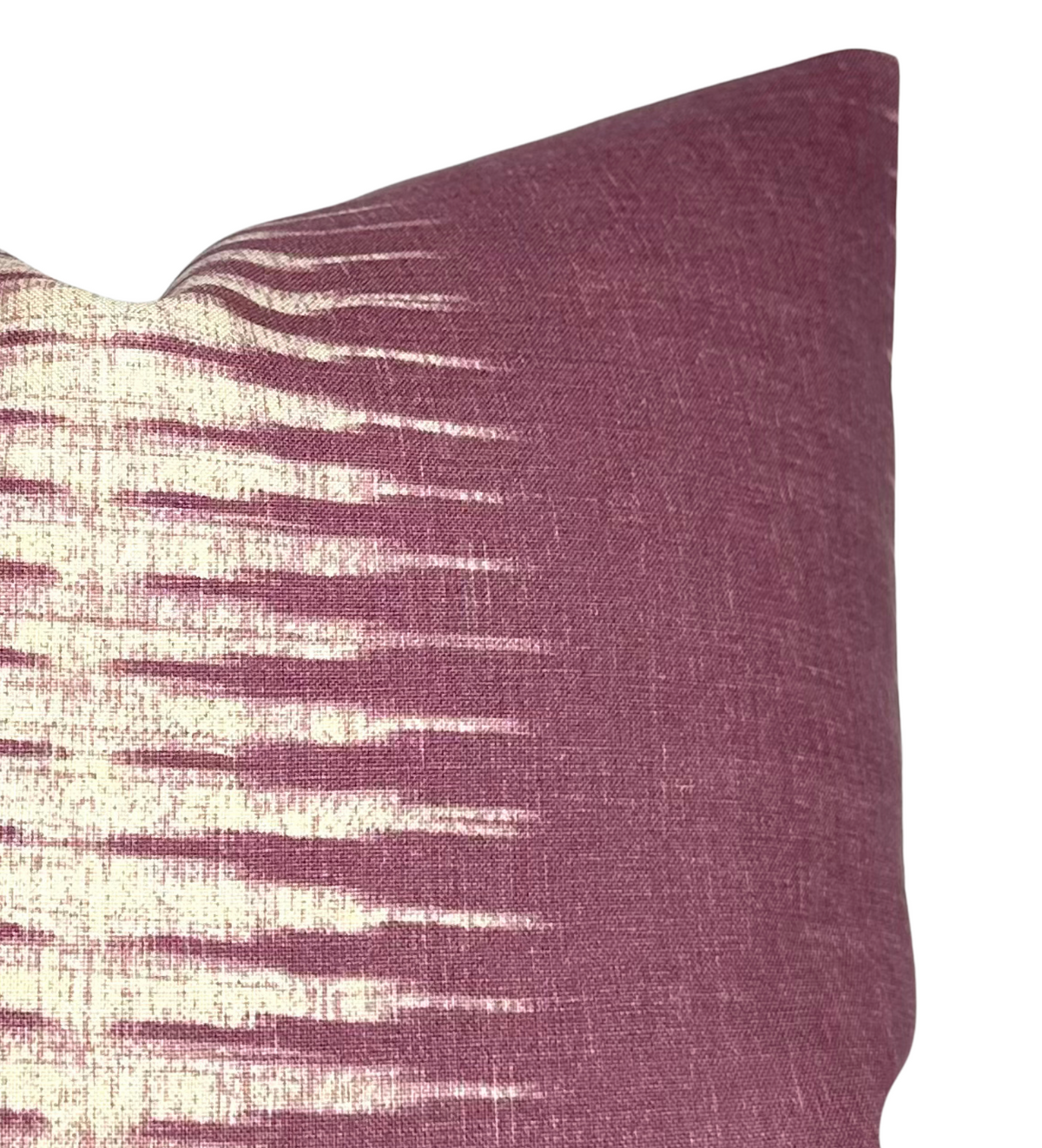 Square pillow cover featuring a gradient ikat pattern with cream spikes fading into a rich mauve background, shown from a close-up angled view.