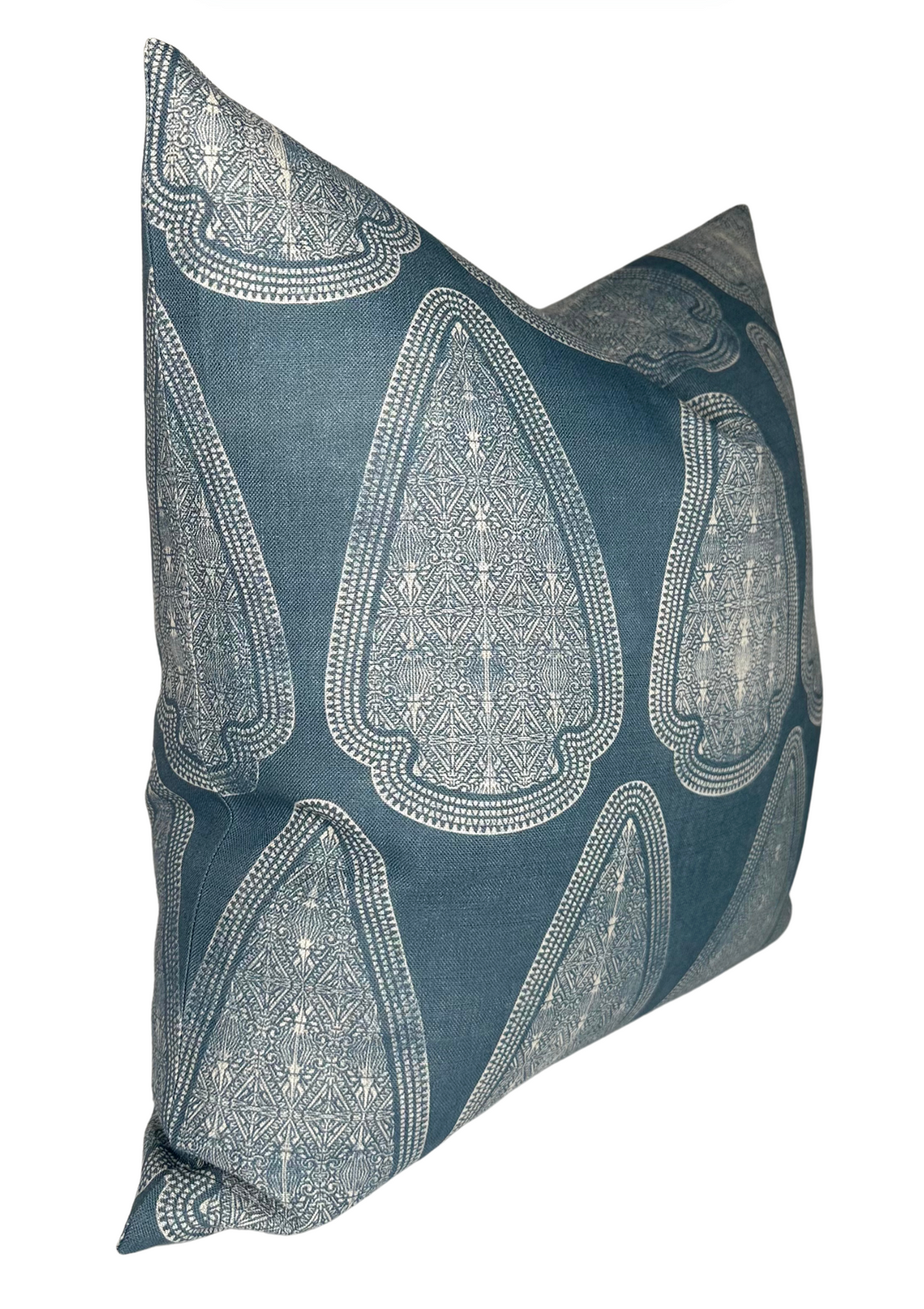 Square pillow cover in lake blue featuring repeated large teardrop-shaped white geometric patterns with intricate line details, shown angled against a white background.