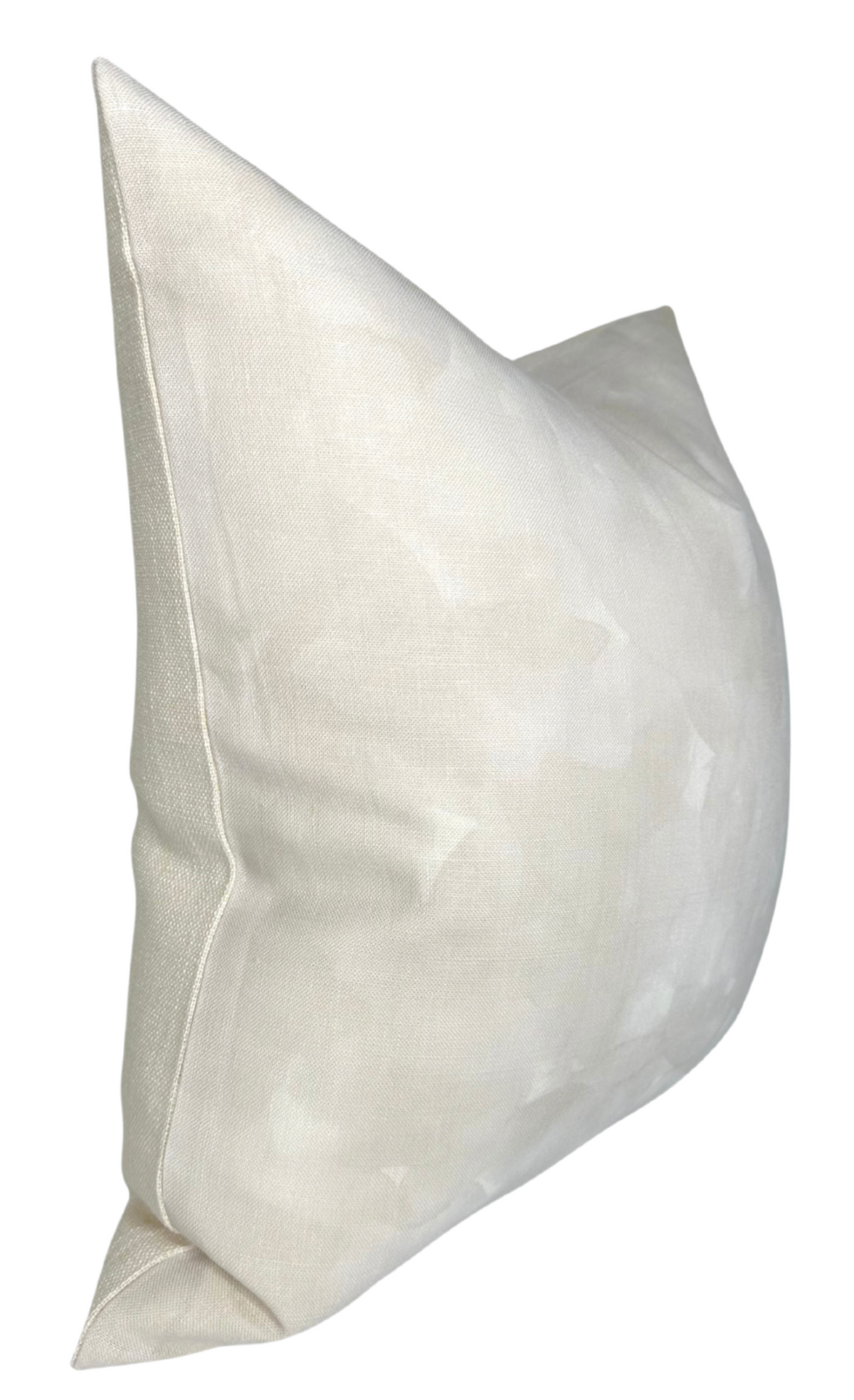 Pearl-colored Casablanca pillow cover with subtle mottled texture and a clean seam along the edge, shown angled slightly from the side.