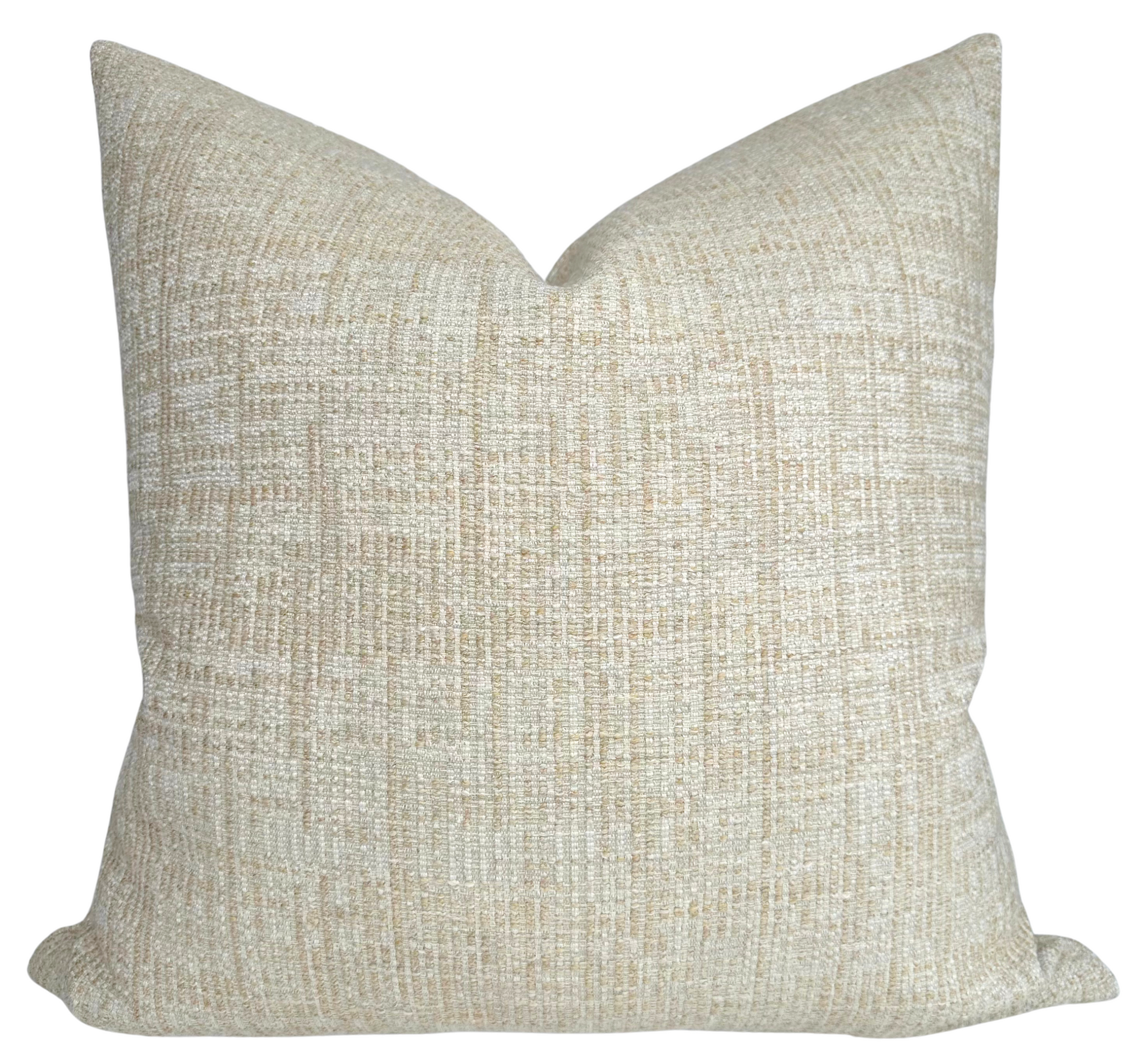 Umbra Pillow Cover in Sand displayed on a chair with neutral interiors