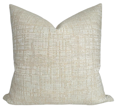 Umbra Pillow Cover in Sand displayed on a chair with neutral interiors