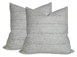 Pair of square Saqqara woven pillow covers in a light gray Albatross color with subtle horizontal textured stripe patterns.