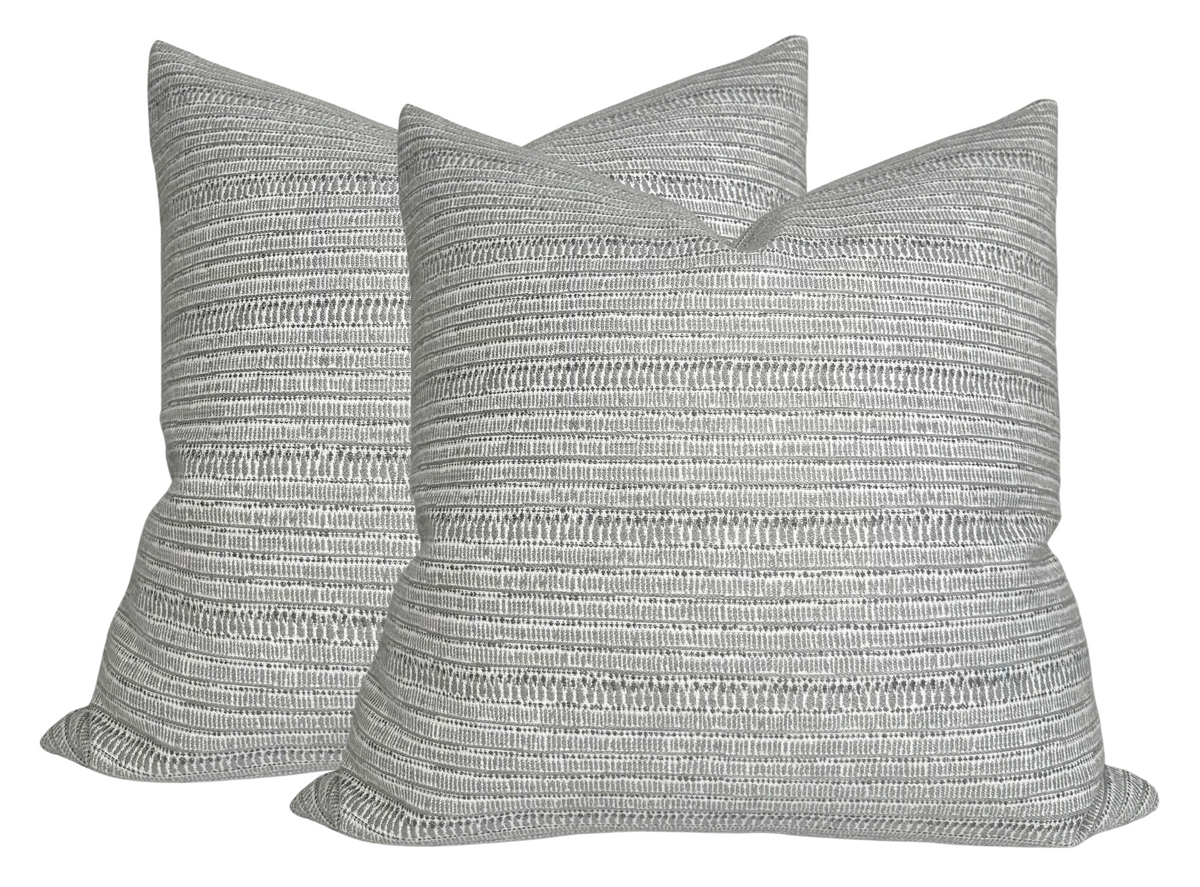 Pair of square Saqqara woven pillow covers in a light gray Albatross color with subtle horizontal textured stripe patterns.