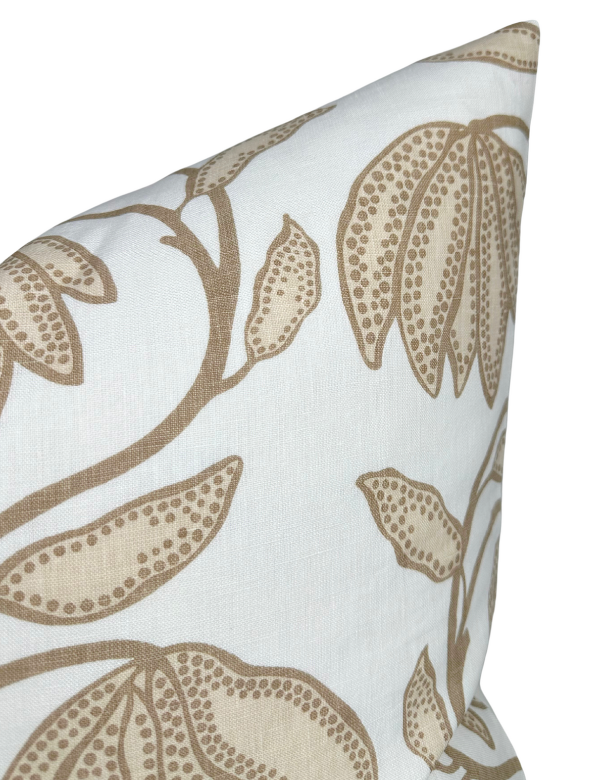 White pillow with beige floral print featuring dotted petal and leaf patterns on thin brown stems, shown in close-up at the top corner.