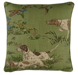 Square green pillow with printed design of three hunting dogs and foliage in natural tones, accented with small blue birds, on a meadow green background.