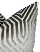 Close-up of a pillow cover featuring a geometric chevron pattern in shades of dove grey and cream with a velvet texture.