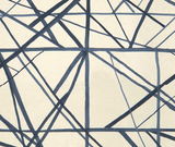 Abstract pattern of intersecting irregular navy and periwinkle blue lines on a cream-colored textile background.