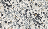 Close-up of a velvet fabric pillow cover with an abstract spotted pattern in shades of black, gray, and beige on a white background.