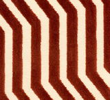 Close-up of Vanderbilt pillow cover fabric with rust-colored velvet zigzag stripes on a cream background, showing texture and pattern detail.