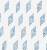 White pillow cover featuring a repeating pattern of diamond shapes filled with intricate blue floral and dot designs, arranged in diagonal rows.