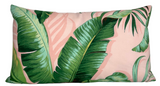 Rectangular pillow with a pink background decorated with large, detailed green palm leaves in various shades and shapes.