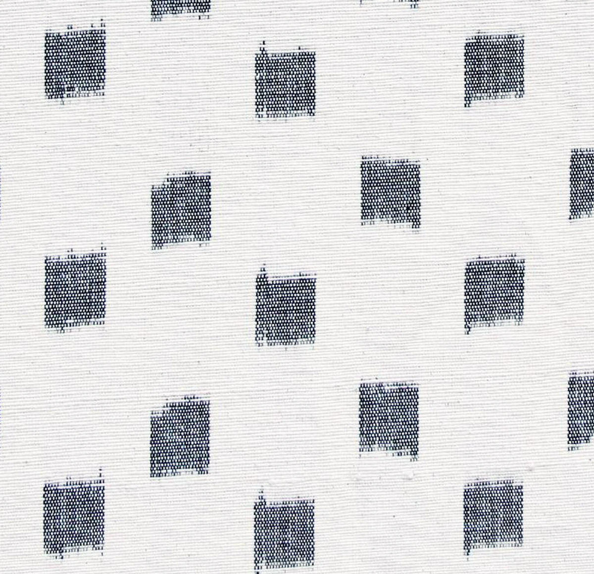 White fabric with an irregular grid pattern of small, slightly faded black squares arranged diagonally and spaced apart.