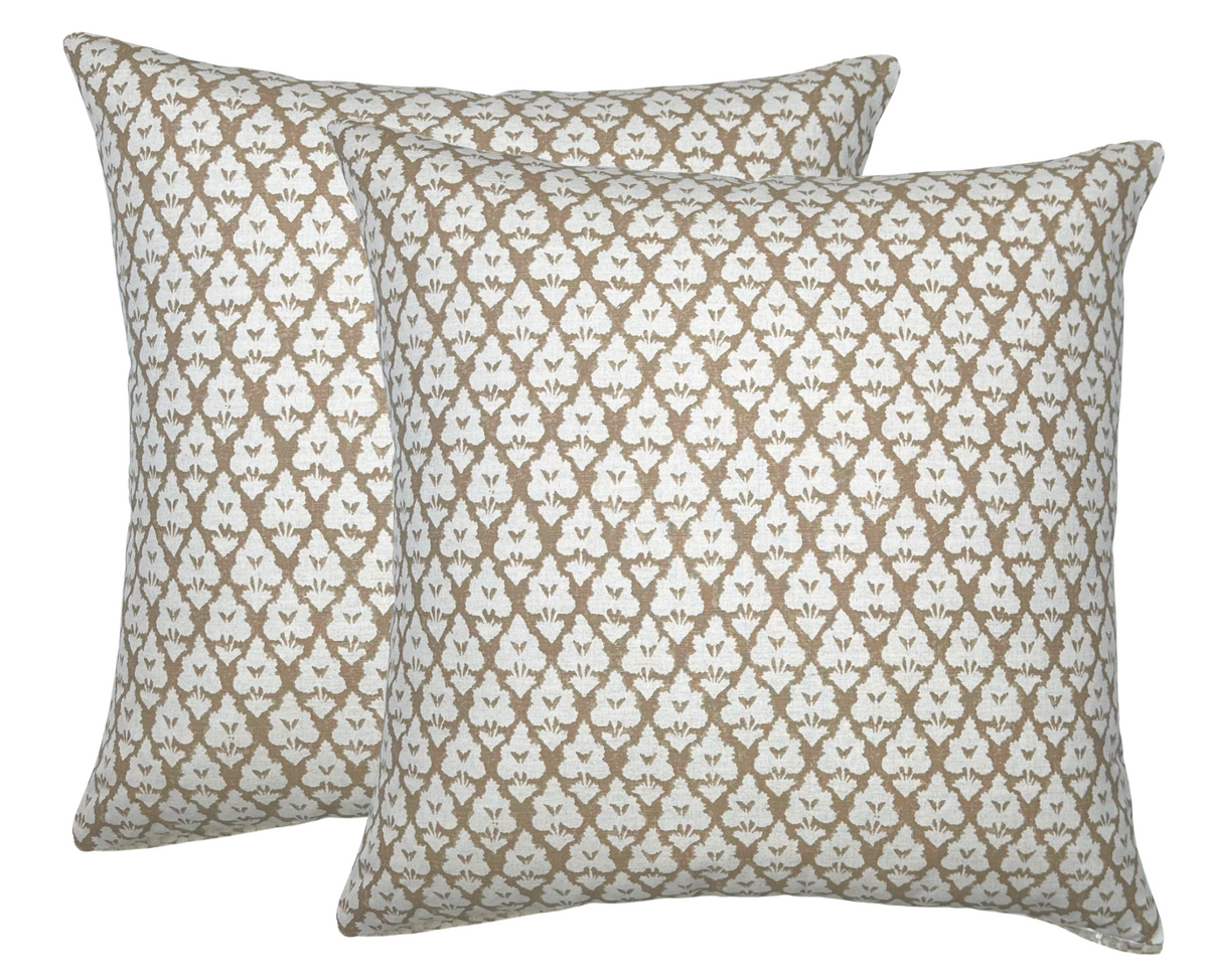 Two square pillow covers with a repeating brown and white intricate floral pattern forming diamond shapes, shown against a white background.