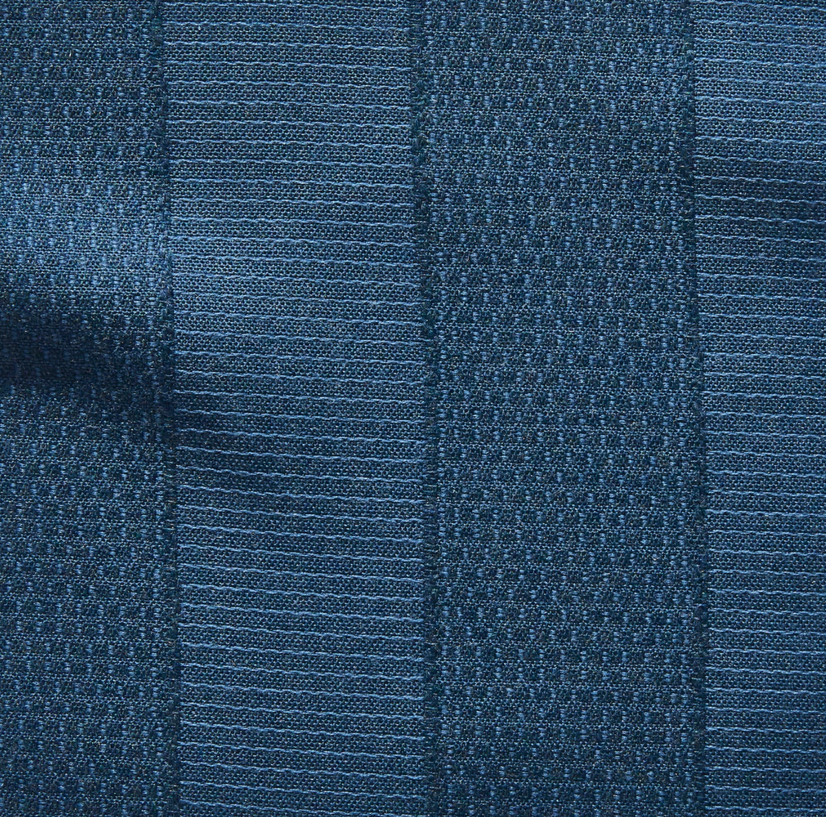 Close-up of midnight blue fabric with alternating textured vertical stripes featuring subtle woven patterns and slightly raised weave details.
