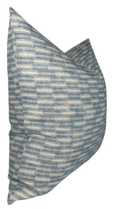 Square pillow cover with a textured horizontal brick-like pattern in shades of muted azul blue and off-white, shown angled on a white background.