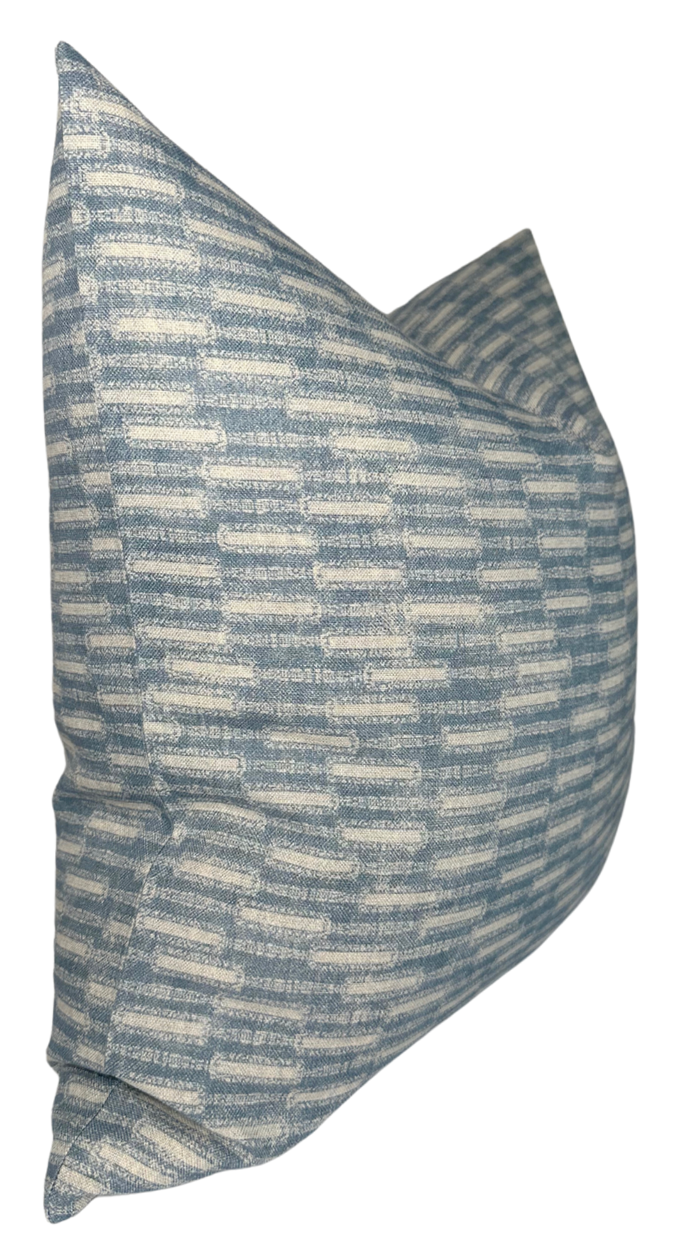 Square pillow cover with a textured horizontal brick-like pattern in shades of muted azul blue and off-white, shown angled on a white background.