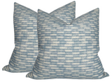 Three square pillow covers with a blue and white rectangular block pattern, creating a subtle textured look, arranged overlapping against a white background.