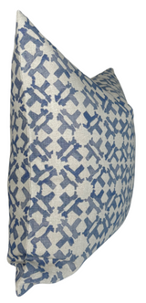 Square pillow cover with an indigo blue geometric cross pattern on a beige textured fabric, shown at an angled side view.