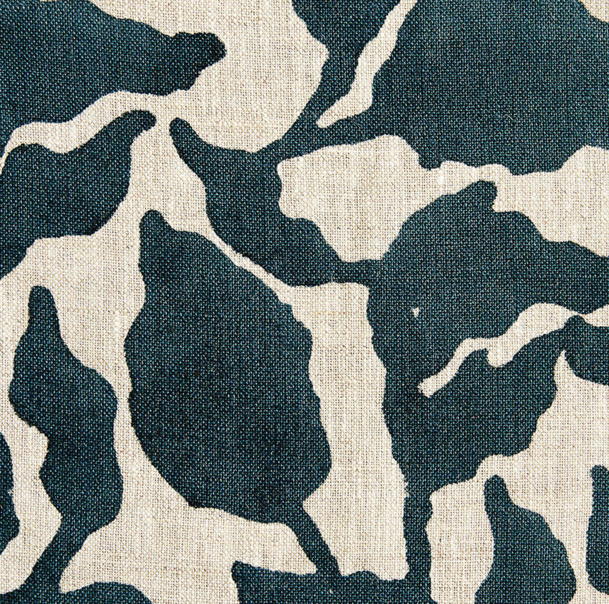 Close-up of Flores Pillow Cover fabric showing abstract navy blue and white organic shapes on textured linen background.