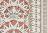 Coral and muted green floral pattern with repeating stylized blossoms and geometric triangle and line borders on a textured off-white fabric background.