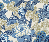 Floral pattern with large blue and beige blossoms and leaves on a cream background, featuring detailed petals and clustered round shapes.