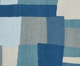 Textile pattern featuring overlapping rectangular blocks in shades of indigo, gray, light blue, and beige with a subtle woven texture.