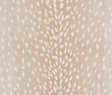 Close-up of a fabric with a beige background and scattered white and light pink antelope-inspired spots arranged in vertical pattern.