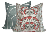 Square pillow with intricate coral and gray floral pattern in front of square pillow with abstract gray and white design.