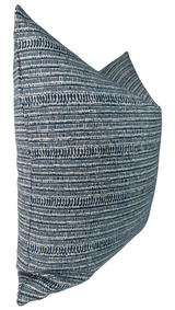 Square pillow with a horizontal striped pattern in varying shades of blue and white, featuring a textured woven fabric and a slightly tapered side profile.