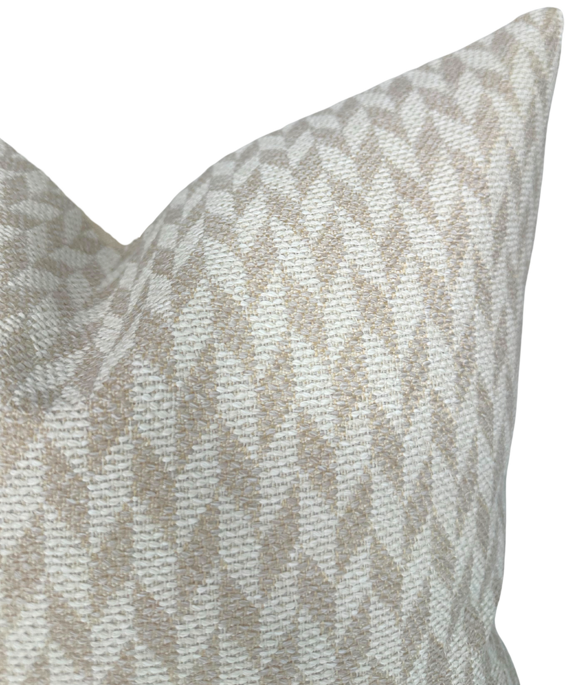 Close-up of a tan brown woven pillow cover with a repeating chevron pattern in neutral tones and a textured fabric surface.