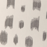 Close-up of Les Touches pillow cover fabric showing irregular gray brushstroke dots on an off-white textured background.