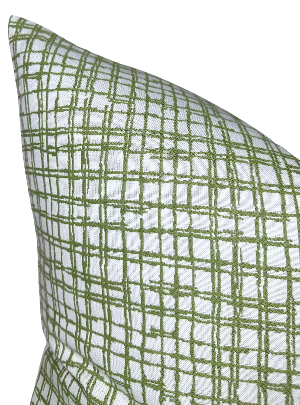 Square pillow with white background featuring an irregular green grid pattern of overlapping lines, angled to show two corner edges.