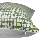 Corner of a square pillow with a sage green intersecting line pattern on white fabric and a visible small white zipper pull on one side.