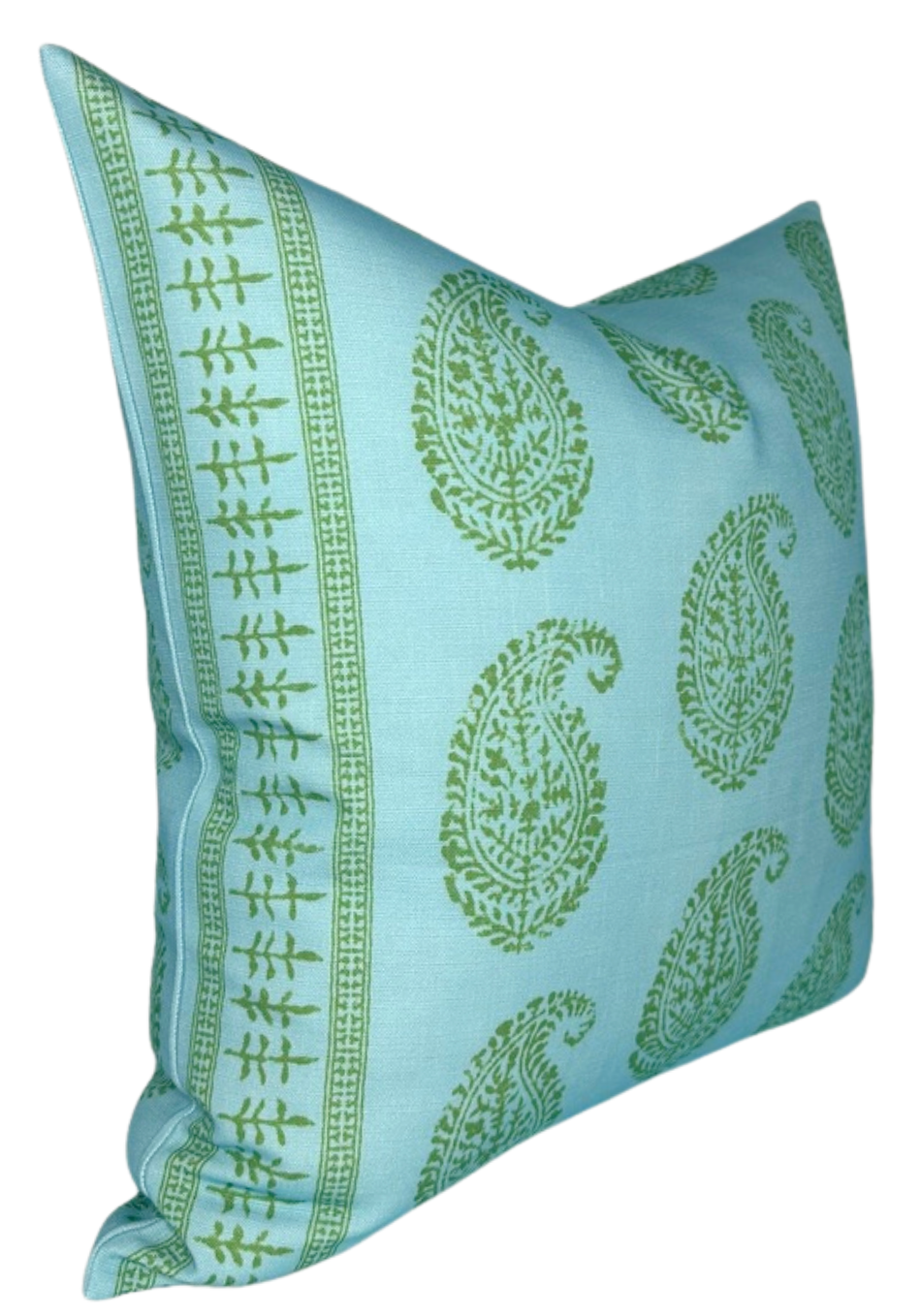 Square pillow with light blue background featuring scattered green paisley and floral motifs, bordered by a green vine pattern on the edges, shown angled from the side.