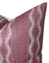 Close-up of a Zanzibar pillow cover in rich maroon with cream wavy vertical stripes featuring intricate dotted and linear patterns, showing fabric texture and corner details.