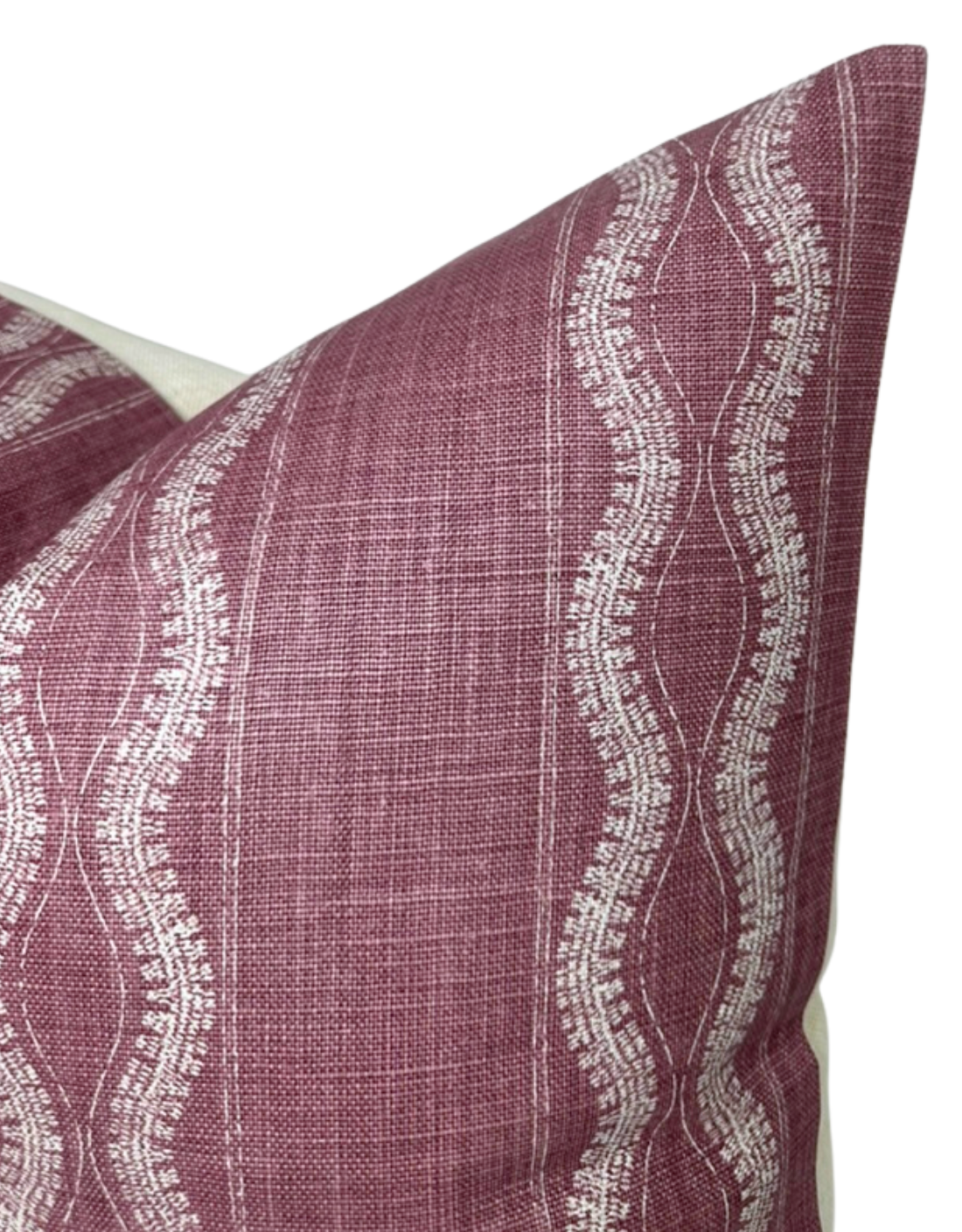 Close-up of a Zanzibar pillow cover in rich maroon with cream wavy vertical stripes featuring intricate dotted and linear patterns, showing fabric texture and corner details.