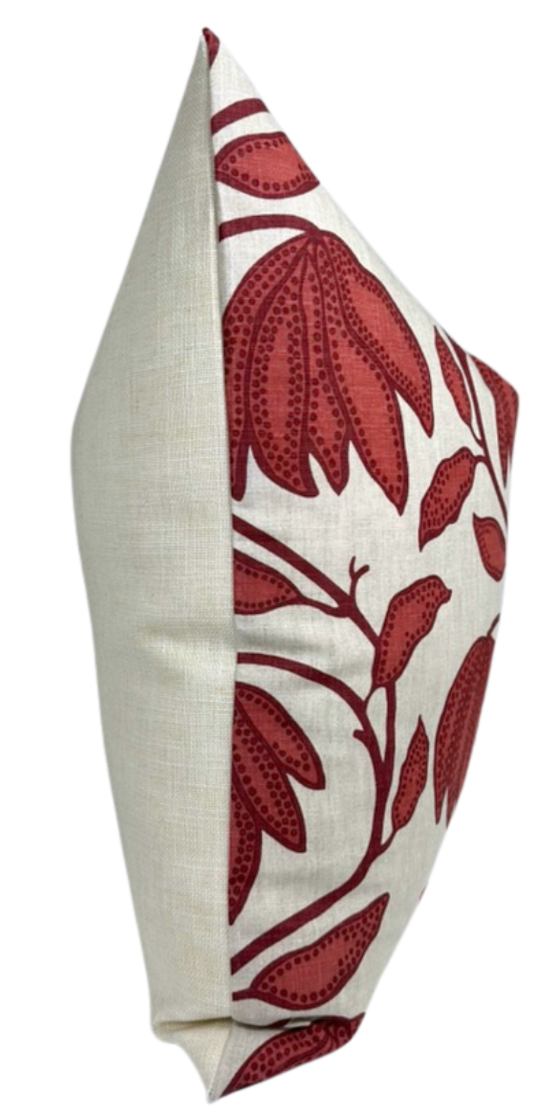 Square pillow with a neutral beige fabric on the back and sides, and a sunbaked red floral pattern with stylized leaves on a white front panel.