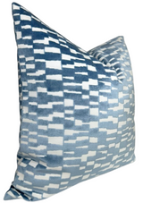 Square pillow with a soft velvet cover featuring a marine blue and white geometric pixelated pattern, shown at an angle highlighting its plump shape.