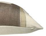 Close-up of a pillow corner with textured woven fabric in silt brown, beige, and off-white horizontal stripes, featuring a small white zipper at the corner.