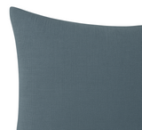 Close-up of a smooth, deep teal velvet pillow cover with subtle weave texture and a neat, slightly curved top edge on a white background.