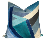 Square pillow cover with an angular geometric pattern in shades of navy, teal, gray, cream, and black velvet textures.