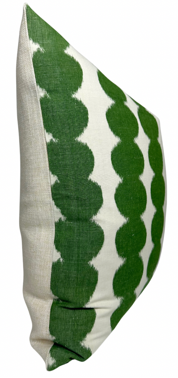 Pillow cover featuring green circular patterns arranged in vertical rows on a white fabric background, with a plain beige back panel.