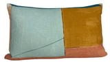 Rectangular pillow with a color-block design of pale blue, mustard yellow, and apricot pink segments separated by thin dark stitching.