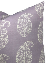 Close-up of a lilac purple pillow cover featuring an off-white paisley pattern with fine leafy details, shown from a slightly angled front view.