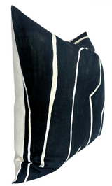 Square pillow cover with black background and irregular white vertical lines, side panel in beige fabric, angled view.
