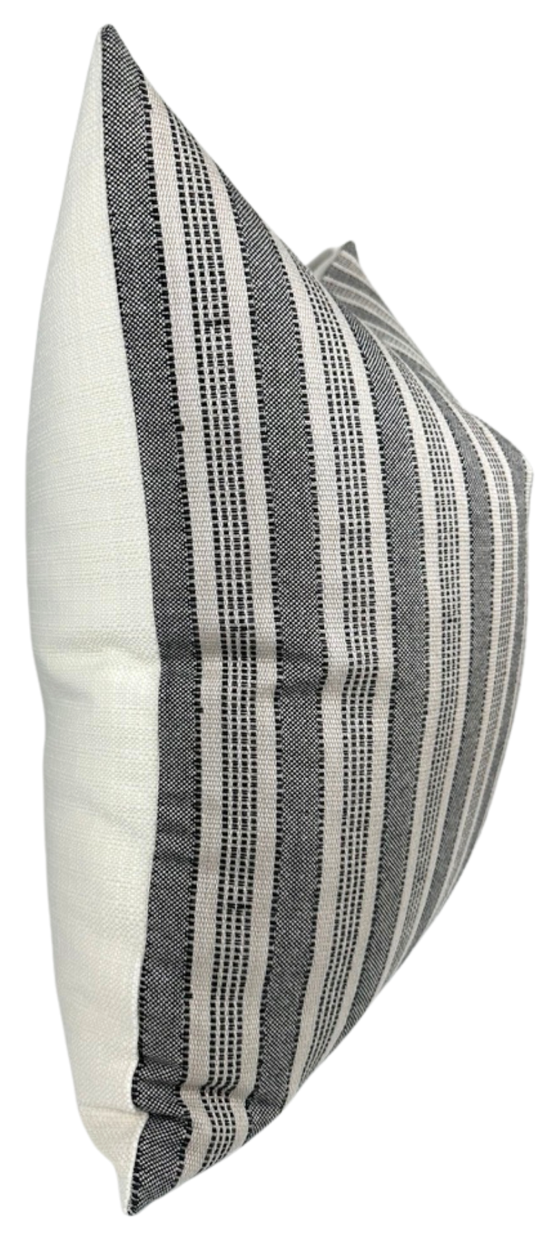 Rectangular pillow with vertical black and charcoal textured stripes on a natural cream background, shown at a side angle highlighting its plush shape.