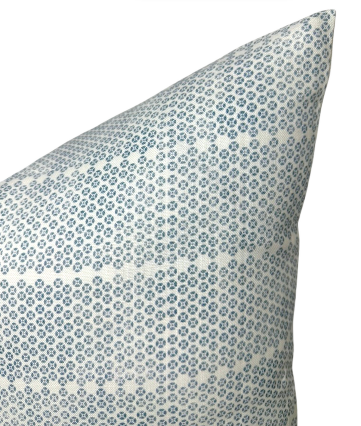 Pillow cover with a repetitive blue and white geometric floral pattern forming a symmetrical, delicate grid across the fabric.