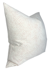 Square pillow cover in off-white fabric featuring a subtle pattern of small blush pink dots evenly distributed across its surface, shown at a slight angle.