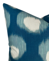 Square pillow cover featuring a blurred circle pattern in shades of blue and white on woven fabric with subtle texture.